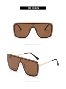 Detail view of large square sunglasses with golden metal temples and brown lenses