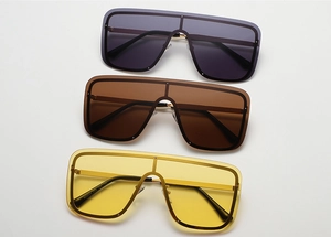Close-up of oversized square sunglasses set in grey, brown and yellow lens options