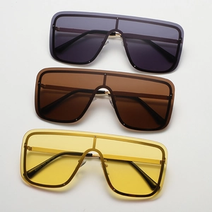 Three pairs of oversized square sunglasses in grey, tea, and yellow with side temple details
