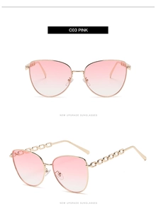 Détail de lunettes de soleil œil-de-chat dégradé rose avec branches chaîne en métal doré