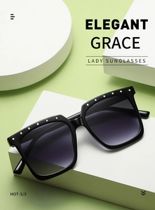 Detail of black square oversized sunglasses with gold rivets and Cat.3 gradient lenses