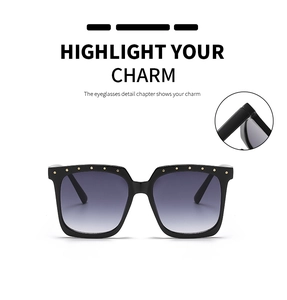 Detailed macro view of the hinge and gold rivet on black square gradient sunglasses