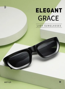 Detail of square black sunglasses with CE mark shown on elegant geometric display blocks