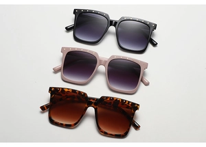 Flat lay detail of square oversized sunglasses with gold stud accents in three colorways
