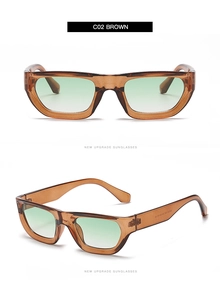 Detail view of rectangular sunglasses in transparent brown frame with green gradient lenses