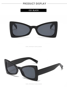 Detail view of triangular cat eye sunglasses in C01 black with dark grey lenses