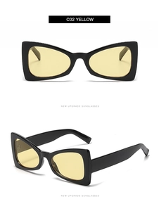 Detail view of triangular cat eye sunglasses featuring black frames and yellow lenses