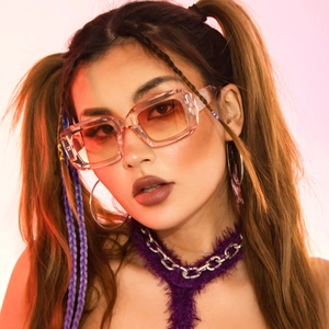 Close-up of square transparent acetate sunglasses with orange gradient lenses on model