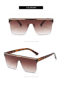 Détail de lunettes de soleil carrées oversize avec verres dégradés et branches écaillées