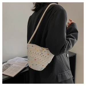 Fashionable white hand-knitted crossbody bag with colorful polka dots and pearl button