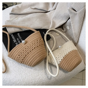 Detailed view of woven crossbody bags featuring elegant large pearl magnetic buckles