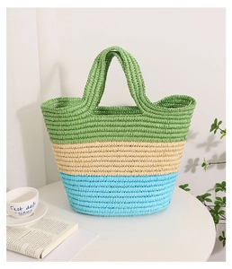 Detail of woven straw tote bag with three-color stripes and handcrafted textures