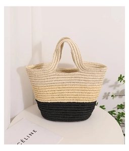 Detail of a large straw tote bag with natural beige and black contrast weave texture