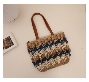 Detail of tricolor striped straw tote bag with fringe accents and leather handles