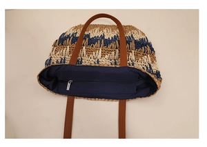 Detail of color-block straw tote with internal lining and secure zipper closure