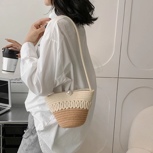 Chic two-tone cotton woven bucket bag with pearl closure and thin crossbody strap