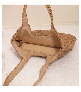 Detailed interior of handmade woven straw bag with zipper pocket and fabric lining
