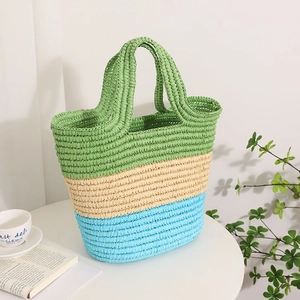 Three-color striped straw tote bag in green, beige, and blue for summer beach vacations