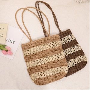 Handmade hollow straw shoulder bag with floral pattern for summer beach vacation