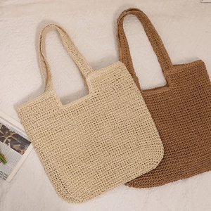 Handmade woven straw tote bags in beige and coffee brown for beach or summer travel