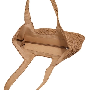 Handmade woven khaki straw tote bag with fabric lining and secure zipper closure for beach