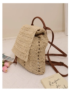 Close-up of hollow straw backpack with premium brown leather straps and buckle detail