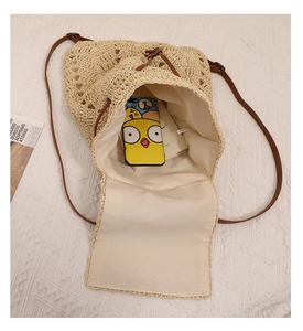 Top view of hollow straw bucket bag showing large capacity interior and drawstring closure