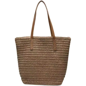Minimalist straw woven tote bag with brown leather handles for summer beach vacations
