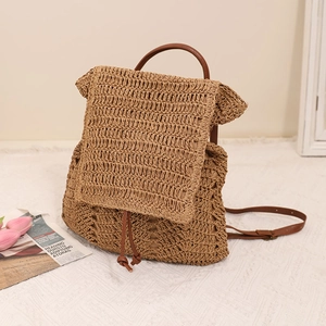 Handwoven straw backpack with brown leather straps and drawstring for beach vacations