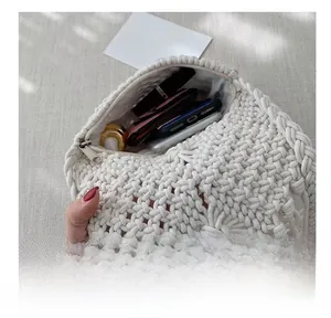 Detail view of cotton rope woven crossbody bag showing interior lining and daily capacity