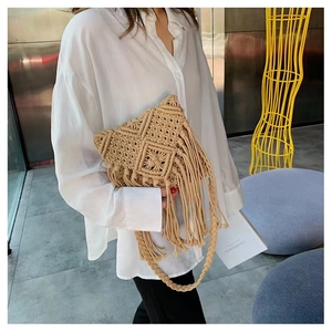 Close-up of bohemian handmade woven crossbody bag with detailed macrame fringes