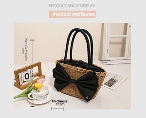 Detailed view of beige straw tote bag with black bow and dimensions labeled