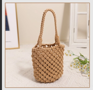 Close-up of minimalist cotton rope handwoven bucket bag with intricate mesh texture