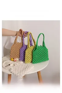 Detail showing dimensions of hollow knit beach bag in multiple colors on a white table
