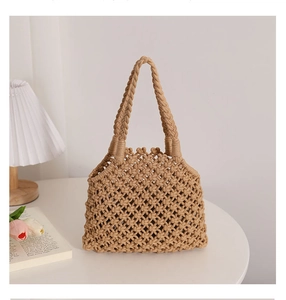 Close-up of hollow cotton rope weave and sturdy handles on natural woven beach tote bag