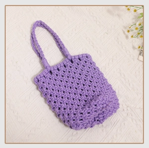 Detailed macro shot of purple woven cotton net handbag featuring hollow diamond mesh pattern