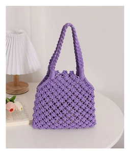 Detailed close-up of purple handmade woven cotton rope handbag with diamond mesh texture