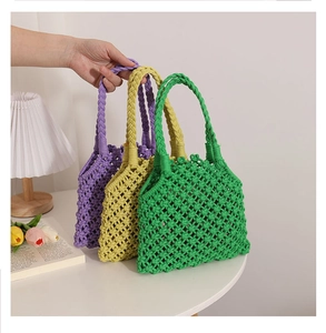 Detail of three colorful macrame woven cotton tote bags showing texture and handles
