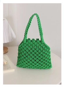 Detail of green handmade crochet weave pattern on a minimalist summer beach tote bag