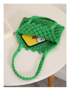 Detail view of green hand-woven cotton rope bag showing interior capacity and texture