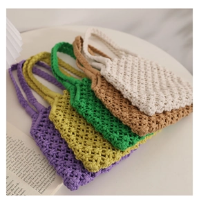 Detail of hollow woven cotton rope bags in purple yellow green camel and off-white