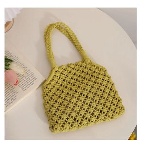 Detailed cross-grid weave of a ginger yellow cotton rope beach tote on a table