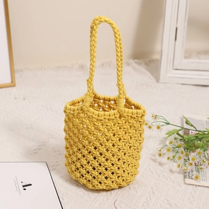 Bright yellow hand-woven hollow knit bucket bag for summer vacation and beach trips