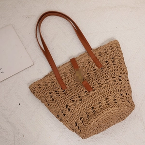 Hollow out woven straw tote bag with brown leather straps for beach vacation