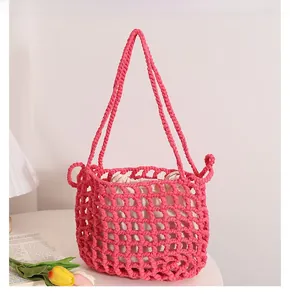 Detail of rose pink hollow mesh woven beach bag with a white drawstring inner pouch