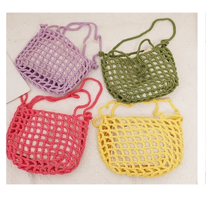 Flat lay of colorful hollow crochet shoulder bags in pink, yellow, green, and purple