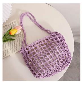 Detail of purple hand-knitted mesh tote bag with crochet texture and drawstring liner