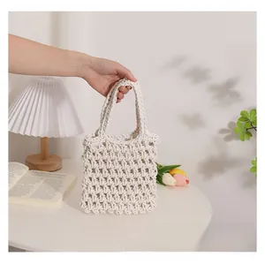 Detail of hand-woven off-white cotton rope tote bag with bohemian hollow mesh design