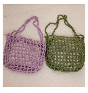Detail of hollow-out cotton weave bags in purple and olive green with inner liners