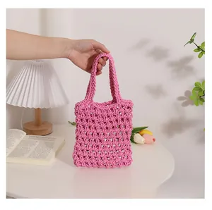 Close-up of pink handmade woven cotton tote bag showing detailed mesh texture and handles